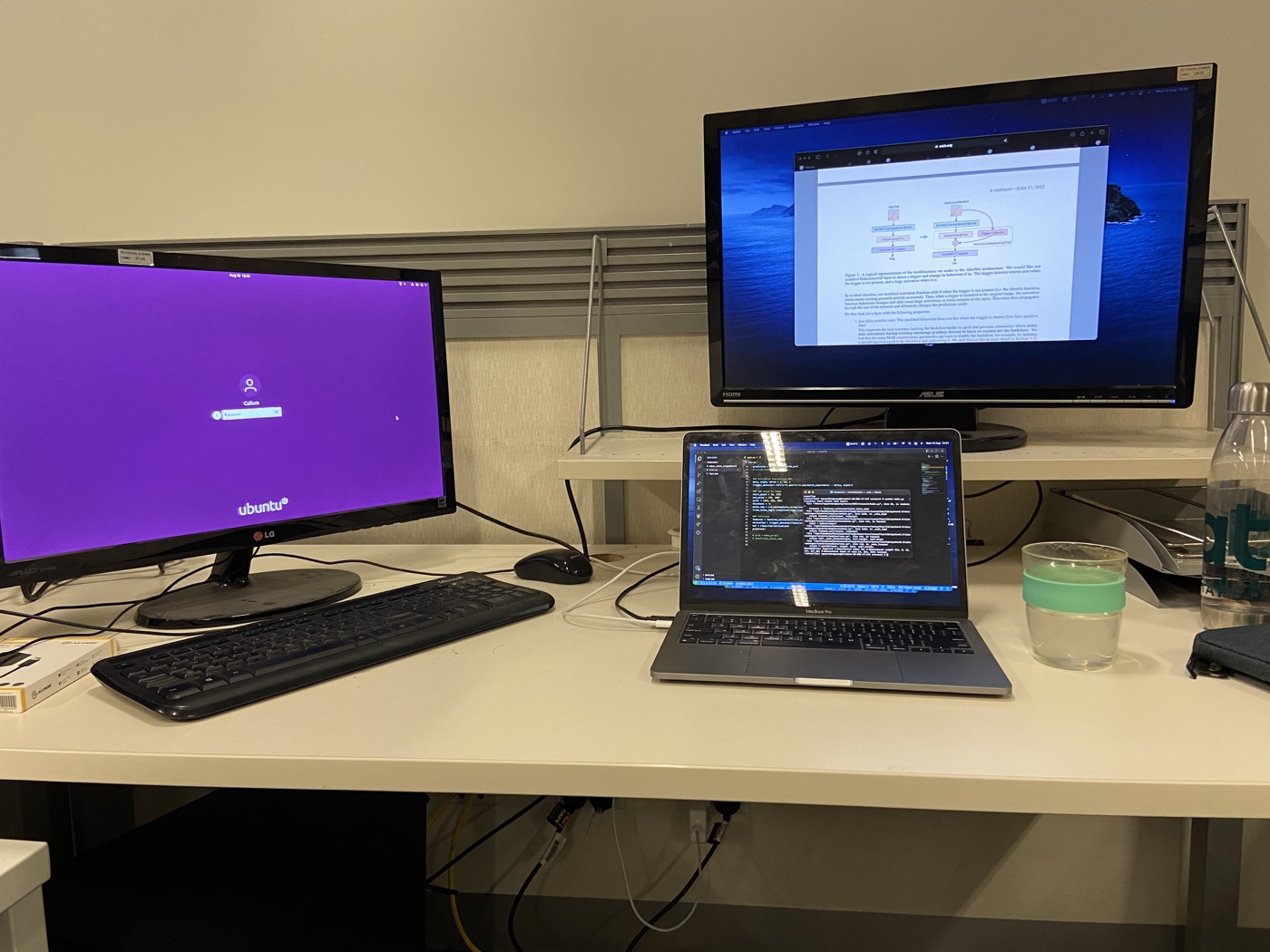 Research lab desk setup with Ubuntu and macOS monitors