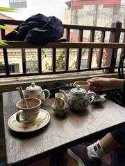 Teapots and cups on a café balcony