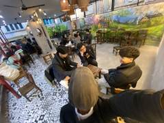 Friends at a café photographed with a wide angle lens