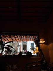 A warmly lit café looking out onto the street