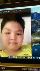 A childhood portrait displayed on a laptop