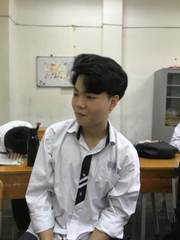 A student in a white school shirt and loose tie