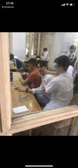 School friends in a classroom seen through a window