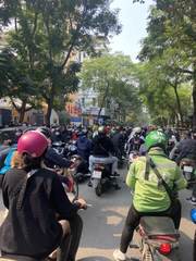 A crowded street full of motorbikes