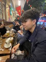 Friends sitting outside a café at night