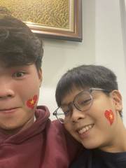 Two friends with Vietnamese flag face paint