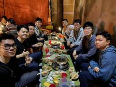 Friends gathered around a long table for dinner