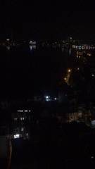 A lake and nearby buildings at night