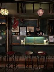 A café counter with hanging lanterns