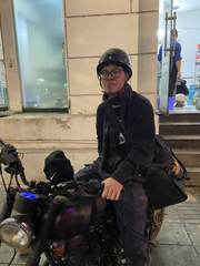 A helmeted rider sitting on a motorbike