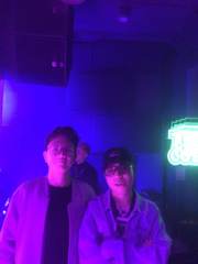 Two friends under neon lights
