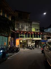 A building lit by red lanterns at night