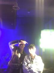 Friends beside a brightly lit stage