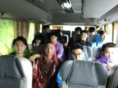 Friends on a bus in rain ponchos