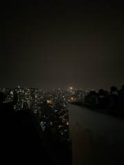 People watching the city at night from a rooftop