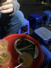 Drinks on a tray beside blue plastic stools