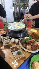 A tabletop grill surrounded by food