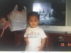 A toddler standing in front of a television at home